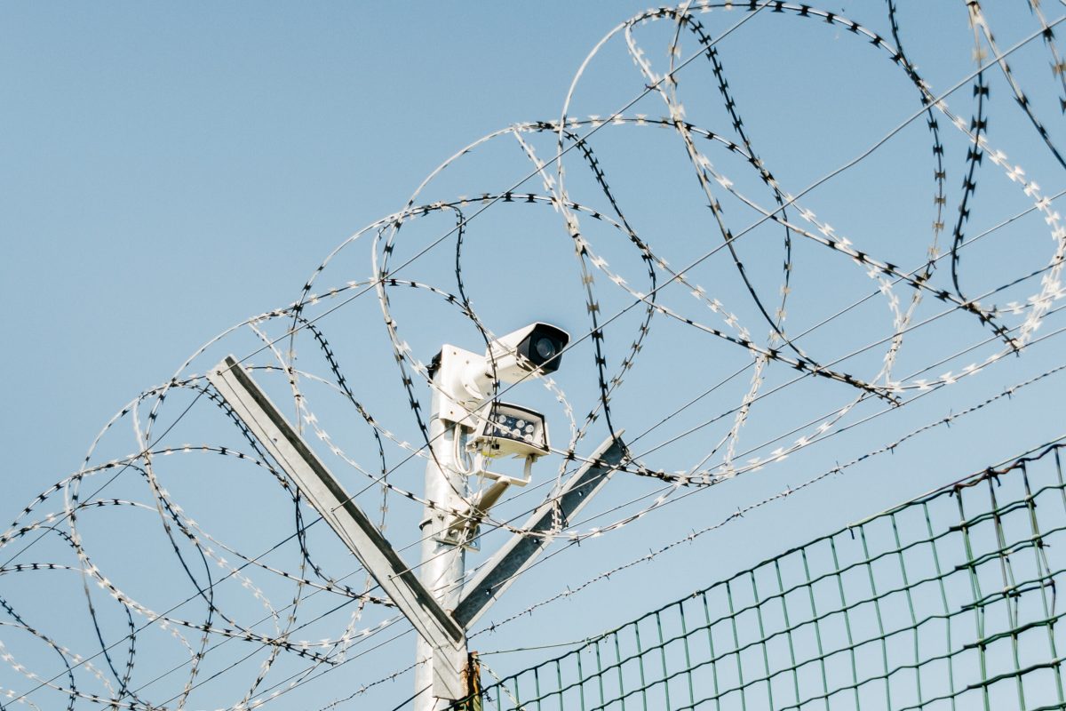 Barbed wire, fence and security camera - dystopian theme